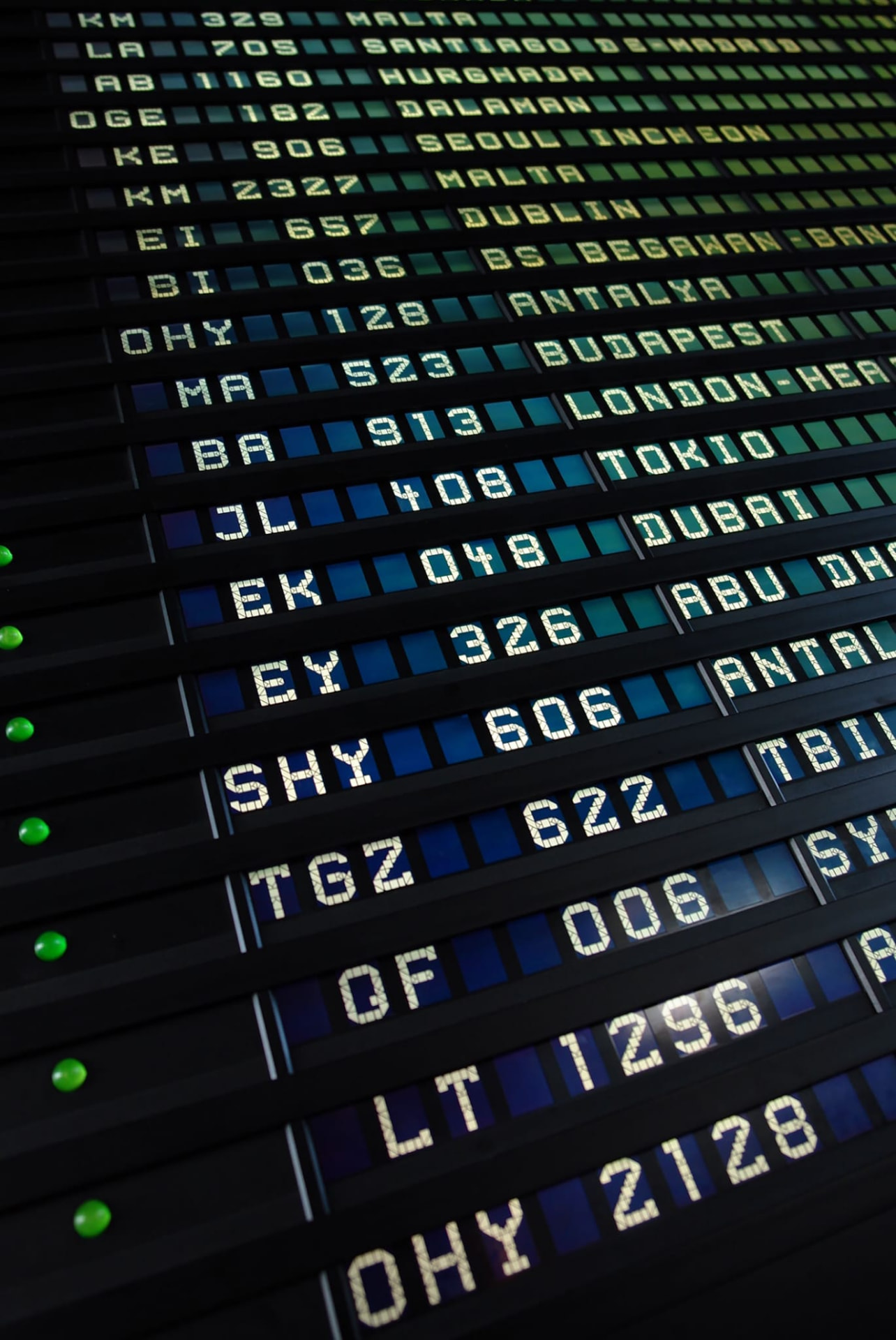 Airport departures board filled with worldwide destinations